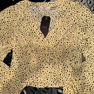 Levi top for women or teens. Yellow in color w/ black flowers.